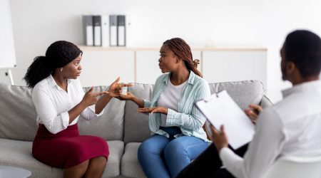 african-american-lesbian-couple-having-consultation-with-psychologist-at-office