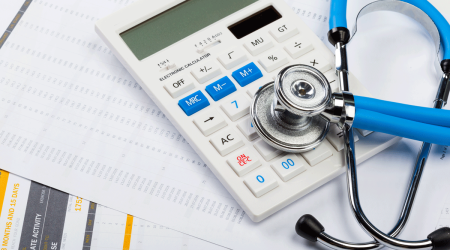 health care costs stethoscope and calculator